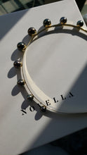 Load image into Gallery viewer, shadow casting on Modern Lux Hair Jewelry ULA Tahitian Pearl Headband in 14k gold plated metal on paper box