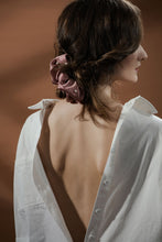 Load image into Gallery viewer, Model in white shirt wearing Modern Lux Hair Jewelry ONLY REAL SILK Scrunchie in Pink embroidered with fresh water pearl