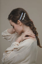 Load image into Gallery viewer, Model in beige blouse wearing modern Lux Hair Jewelry GIONNY Baroque Pearl Barrette and SELENE Blue Chalcedony Barrette on the side of her braided hair