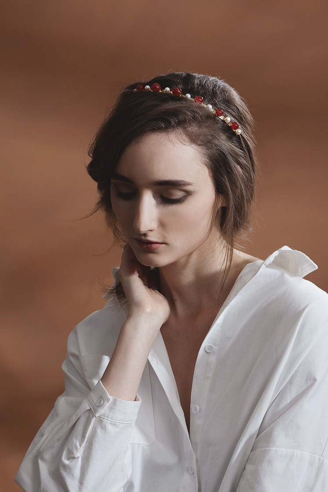 Lady in white shirt wearing modern lux hair Jewelry VICTORIA Headband set with Carnelian beads and fresh water pearl in 14k gold plated metal