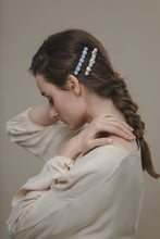 Load image into Gallery viewer, Model in beige blouse wearing modern Lux Hair Jewelry GIONNY Baroque Pearl Barrette and SELENE Blue Chalcedony Barrette on the side of her braided hair
