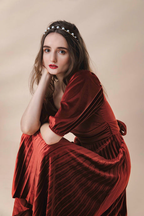 Model in red dress wearing modern lux hair Jewelry ESTELLE Howlite Headband in 14k gold plated metal 