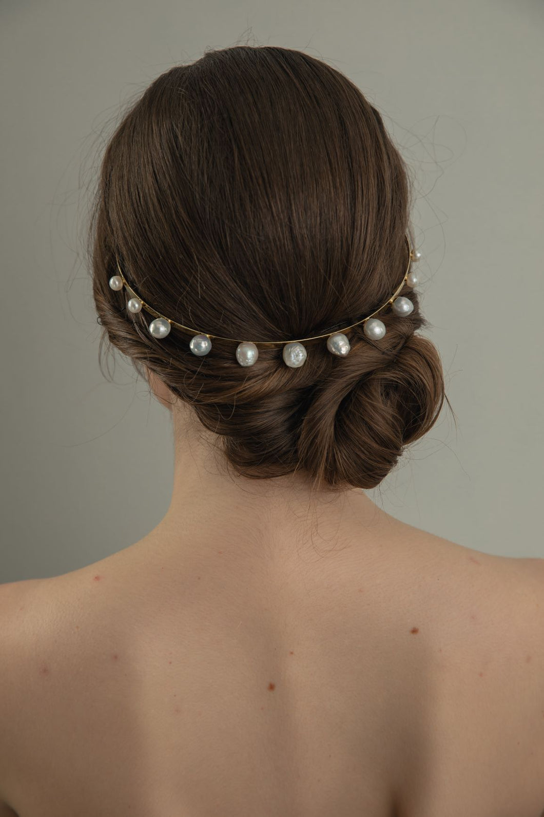 Model wearing Modern Lux Hair Jewelry GIONNY Baroque Pearl Headband in 14k gold plated metal  at the back of her hair updo